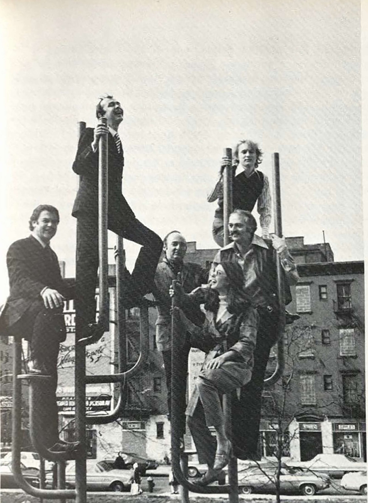 Black and white photo of six individuals on playground equipment in New York City