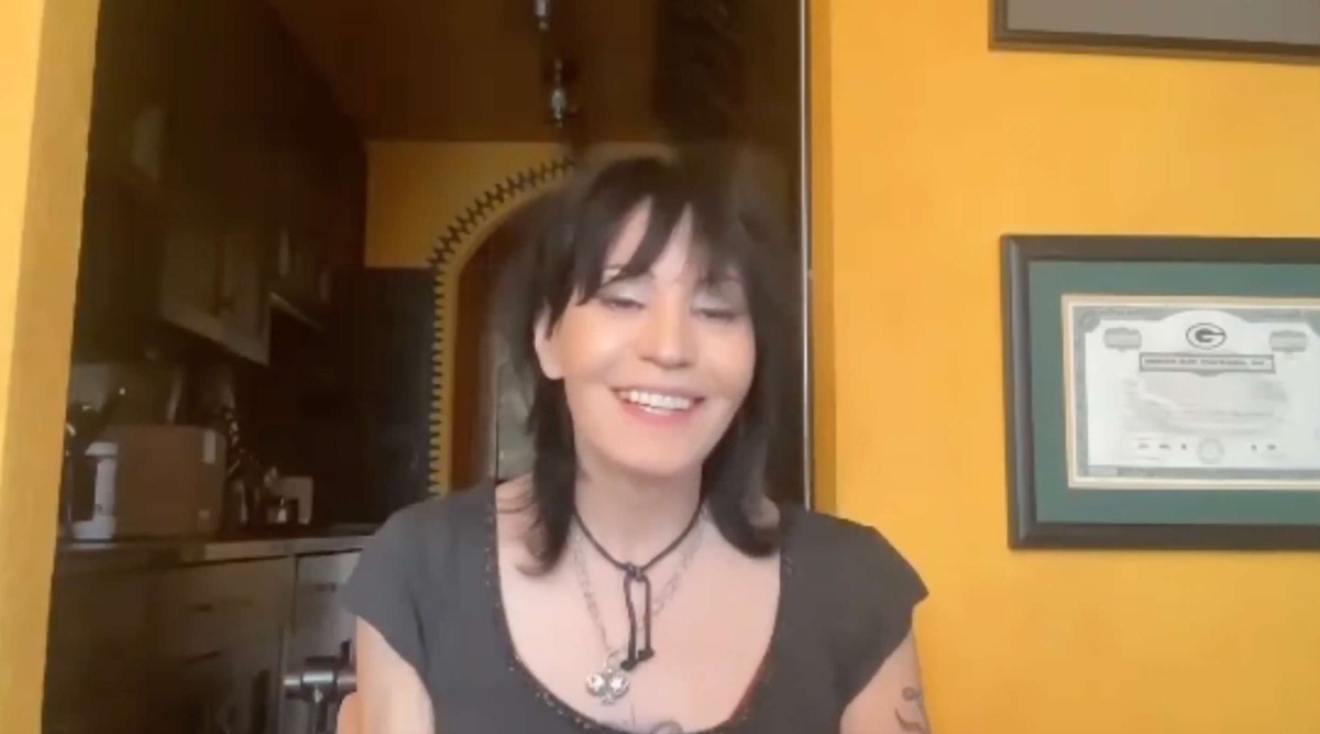Picture of legend Joan Jett in front of a yellow wall